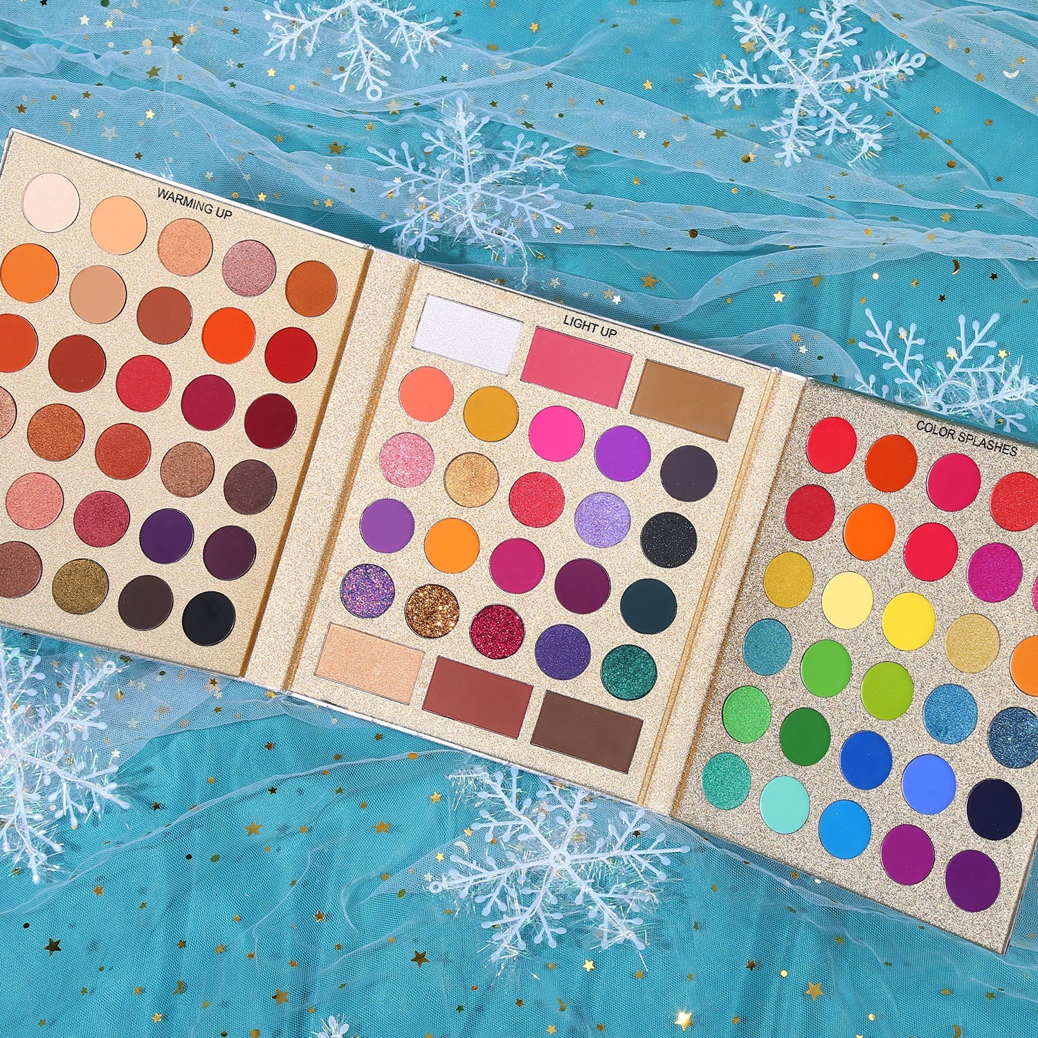 Close-up of warm-toned eyeshadows from UCANBE Pretty All Set Gold Edition showing rich reds, oranges, and browns