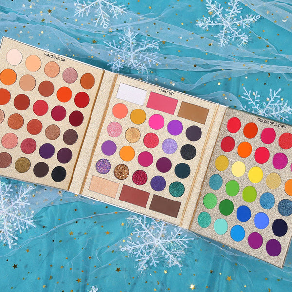 Close-up of warm-toned eyeshadows from UCANBE Pretty All Set Gold Edition showing rich reds, oranges, and browns