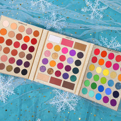 Close-up of warm-toned eyeshadows from UCANBE Pretty All Set Gold Edition showing rich reds, oranges, and browns